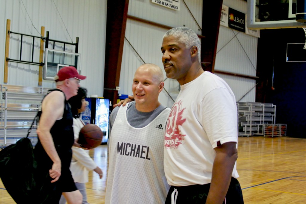 Michael D. McClellan and Julius Erving share a moment after the action on the court.